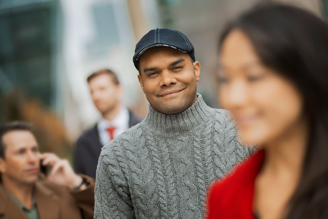 group-of-people-on-the-go-keeping smiling man surrounded by city people