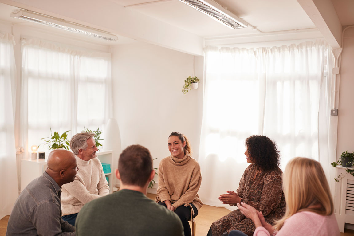 woman-speaking-at-support-group-meeting group therapy