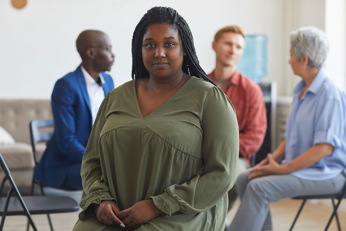 African American woman attending group therapy
