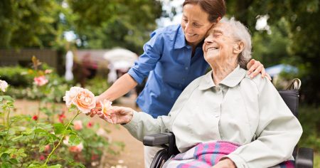 Adobe Express - file (31) Woman and caregiver admiring roses in a garden
