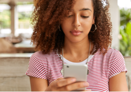 Adobe Express - file teen girl looking at her phone