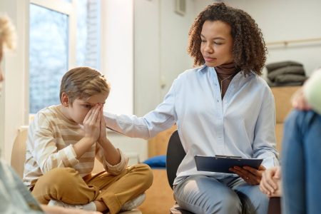 Therapist comforting boy