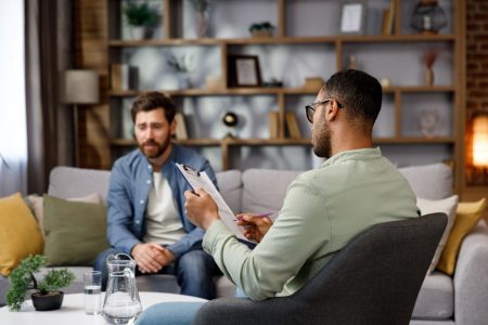 SCS Blog 2visit-to-a-psychologist-a-man-sits-on-a-couch-and-2024-11-27-11-24-41-utc Man visiting psychologist