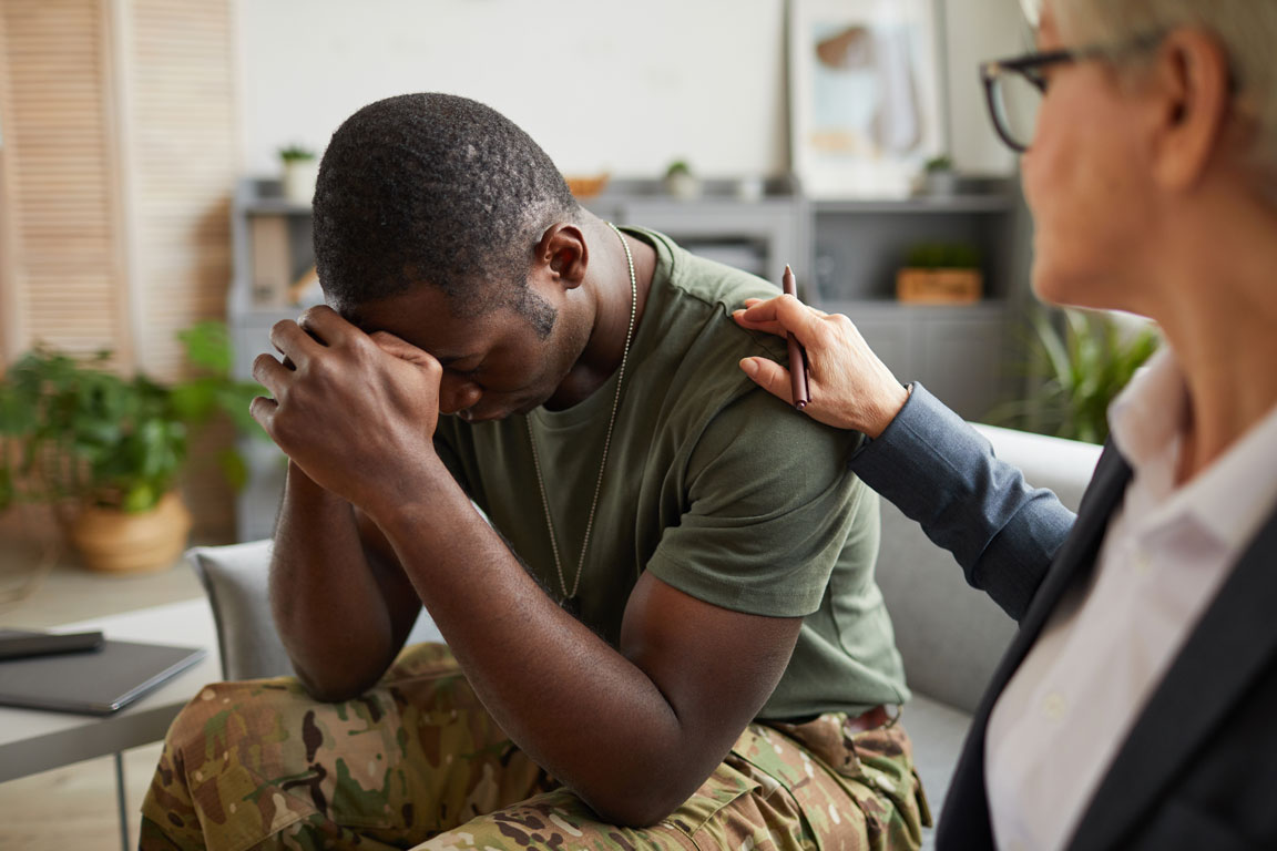 man-suffering-from-depression soldier talking about PTSD with therapist