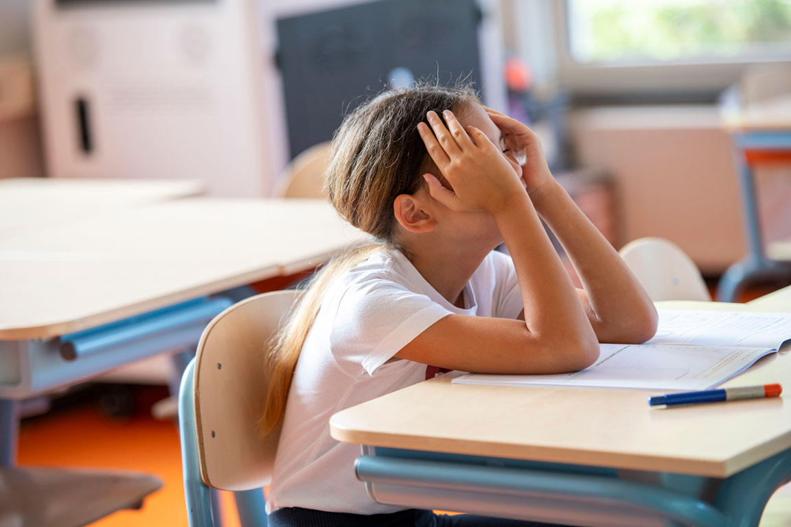 girl stressed at school desk