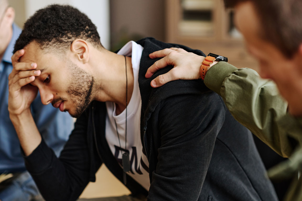 man suffering from depression at group therapy